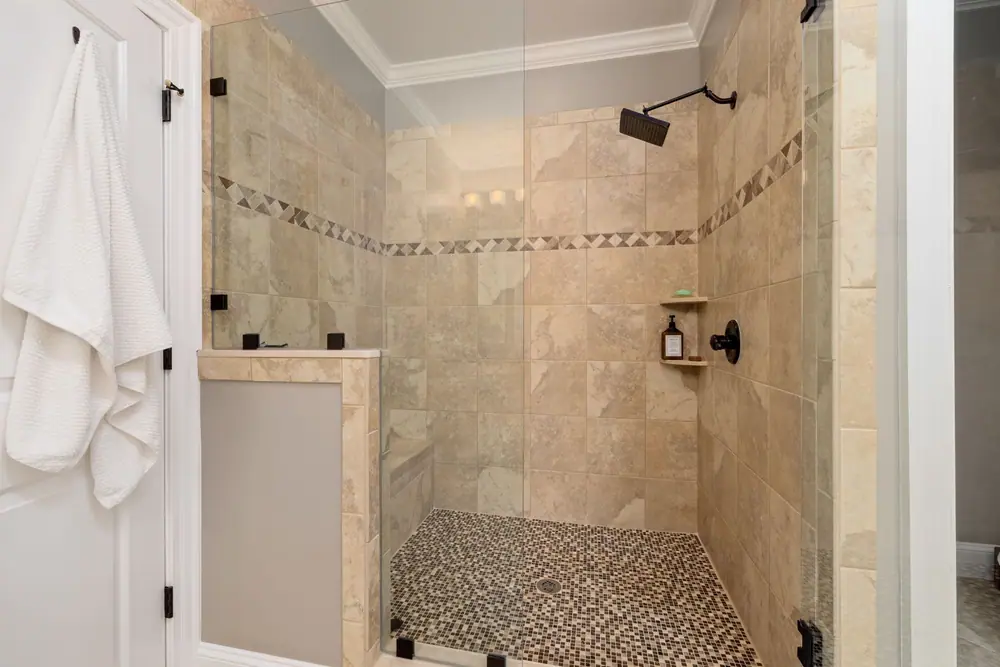 Tiled shower with a pebble floor and niche
